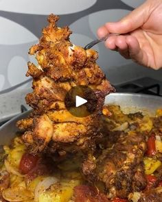 someone is cooking food in a pan on the stove with a fork and spoon stuck into it