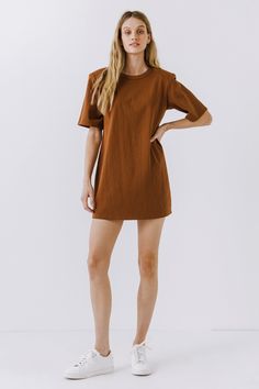 This Shoulder Pad T-Shirt Dress is a wardrobe must-have! Featuring a stylish round neckline, short sleeves, and a boxy silhouette, it's the perfect addition to any outfit. Our unique shoulder pad insert adds structure and a touch of sass, making this dress a standout. With its comfortable fit and comfortability, you'll look amazing no matter what the occasion. Show off your fashion-forward style with this shoulder-pad t-shirt dress! Shoulder pad inserted Round neckline Short sleeves Boxy silhoue Fall Relaxed Fit Short Sleeve T-shirt Dress, Brown Oversized Short Sleeve Dress, Chic Oversized Short Sleeve Mini Dress, Relaxed Fit Short Sleeve T-shirt Dress For Fall, Solid Color Cotton T-shirt Dress With Crew Neck, Short Sleeve Everyday Fall Dresses, Everyday Short Sleeve Fall Dresses, Cotton Crew Neck T-shirt Dress, Oversized Short Sleeve T-shirt Dress