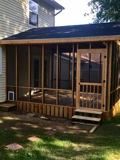 a screened porch in front of a house