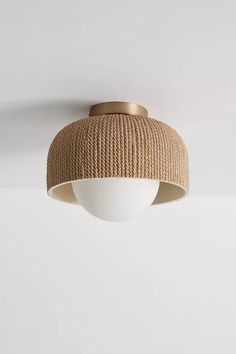 the light fixture is hanging from the ceiling, and it has a beige fabric covering