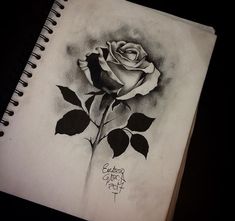 a drawing of a rose on a notebook