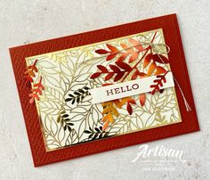 a card with leaves and the word hello written on it