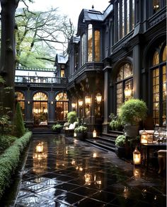 an outdoor courtyard with lit candles and potted plants