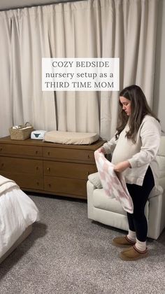 a pregnant woman sitting on a chair in front of a bed with the caption cozy bedside nursery setup as a third time mom