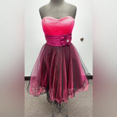 Brand New Homecoming Dress Size: L (11) Color: Fuschia/Black *Comes With Straps* Brand New With Tags! 5974 Pink Mini Length Evening Dress For Homecoming, Pink Mini Evening Dress For Homecoming, Pink Fitted Bodice Evening Dress For Homecoming, Pink Mini Length Evening Dress For Prom, Pink Mini Evening Dress For Prom, Pink Formal Dress For Prom Season, Pink Formal Dress For Prom, Pink Dressy Evening Dress For Prom, Pink Fitted Dressy Evening Dress