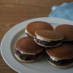 some pancakes are on a white plate with chocolate