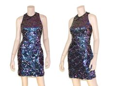 "This 80s-era trophy dress features a fun mermaid scale pattern of iridescent purple sequins and gold beads, a halter neck bodice with open back, and mini length skirt. Perfect for holidays, special occasions, or any time you need to glam it up a bit. Dress is unlined and zips up the back. Best fits size xs or small (please check measurements below). Accessories not included. Payment plans available. Approximate Flat Measurements: Multiply times 2 for bust, waist, and hip measurements. For best Glamorous Fitted Sequin Dress For Summer, Fitted Disco Dress With Contrast Sequin, Fitted Sequin Dress For Costume Party, Purple Fitted Mini Sequin Dress, Fitted Purple Sequin Mini Dress, Fitted Purple Mini Sequin Dress, Fitted Mermaid Sequin Dress For Prom Season, Fitted Mermaid Sequin Dress For Prom, Fitted Purple Sequin Dress For Summer