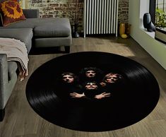 the rolling stones on a vinyl record rug in a living room with brick wall and radiator