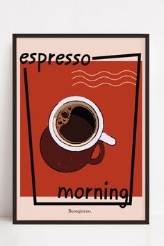 a cup of coffee sitting on top of a table next to a sign that says espresso morning