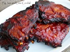 three pieces of barbecue ribs on a white plate