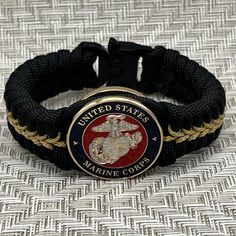 This is an officer Marine Corps paracord bracelet. Silver and gold plated Eagle Globe and Anchor. Makes a perfect USMC gift for any veteran or active duty Marine. Marine Moms and Dads will love this bracelet too. Unique top shelf quality jewelry. Great retirement gift. Semper fi. *Silver & gold plated officer Eagle Globe & Anchor *1 1/4" wide USMC medallion. Only 9mm thick *3/4" wide weave *Very sturdy and durable *Quality Cobra tactical buckle *Very comfortable *I am an official USMC licensee; Usmc Retirement, Usmc Gifts, Eagle Globe Anchor, Eagle Globe And Anchor, Military Gift, 550 Cord, Marine Mom, Semper Fi, Military Gifts