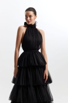 Black Halter Neck Tie Up frilled Evening Dress The Black Halter Neck Tie Up frilled Evening Dress This stunning dress features a halter neckline and a beautiful open back adorned with intricate lace detailing making it a perfect choice for an evening party. Chic Black Halter Dress With Ruffles, Fitted Black Halter Dress With Ruffles, Black High Neck Evening Dress For Gala, Halter Neck Backless Dress With Ruffles For Parties, Black Halter Neck Dress For Gala, Black Ruffled Skirt Evening Dress, Sleeveless Ruffles Halter Cocktail Dress, Black Ruffled Skirt Dress For Evening, Elegant Black Halter Dress With Ruffles