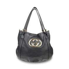 Gucci 'Britt' hobo bag in black smooth leather with with a large GG plaque in gold hardware. Features dual top buckle handles and a detachable crossbody strap. Brand = Gucci Condition = 7/10, Good. Some wear to leather body, scratching in metal hardware, wear to crossbody strap Dimensions = 16" x 13" x 0.25" top Handle = 9.5" Strap Drop = 12' Material = Leather Hardware = Soft Gold SKU = 10806-68 Gucci Bag With Gold-tone Hardware And Top Handle, Gucci Top Handle Bag With Gold-tone Hardware, Gucci Double Handle Bags With Gold-tone Hardware, Gucci Crossbody Satchel With Gold-tone Hardware, Chic Gucci Crossbody Satchel, Gucci Satchel With Top Handle And Branded Hardware, Gucci Shoulder Satchel With Gold-tone Hardware, Gucci Satchel With Gold-tone Hardware, Gucci Bags With Detachable Strap