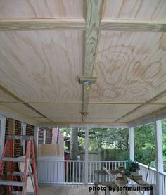 the inside of a house under construction with wood planks on the ceiling and windows