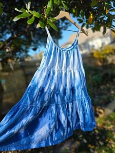 Indigo Hand-Dyed Dress- One a Kind This spaghetti strap dress was hand dyed in indigo dye after being hand sewn with the unique design.  I hand dyed this line of dresses through Shibori, a Japanese dyeing technique that includes bundling, binding and/or folding the fabric with a resist. The results are a wonderful surprise with organic and geometric patterns. Shibori techniques have been used for thousands of years but I recently learned and fell in love with it myself. These works of art are perfect for any time of the year. Warm it up with a light jacket for those summer nights we all love so much. Dress it up with some cowgirl boots. Add your favorite leggings and a cute sweater cardigan for the cold weather season. Just saying ; ) Old Navy 96% Cotton 4% Spandex Sizes available: 1- Smal Casual Tie Dye Dress With Spaghetti Straps, Summer Tie-dye Dress With Natural Dye, Summer Tie Dye Dresses With Natural Dye, Summer Tie Dye Dress With Natural Dye, Hand Dyed Blue Bohemian Dress, Bohemian Hand Dyed Blue Dress, Washed Summer Beach Dress, Summer Beach Dress, Washed, Tie Dye Cotton Sundress