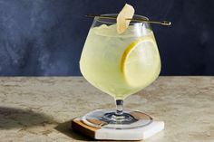 a glass filled with lemonade sitting on top of a counter