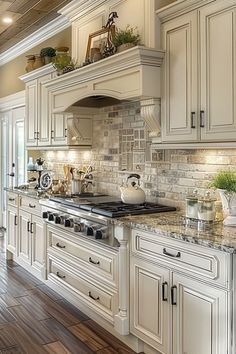 a large kitchen with white cabinets and wood flooring, along with an island in the middle