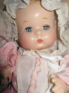 an old fashioned baby doll with blue eyes