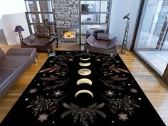 a living room area with couches, chairs and a rug on the floor that has three phases of the moon