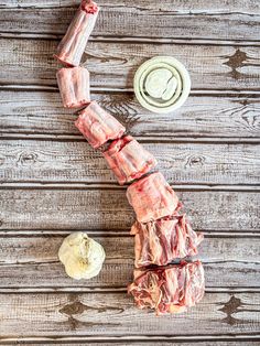 raw meat is being cut into pieces on a wooden table