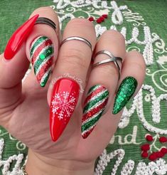 Handmade Red and Green Christmas Nails, Sparkling Winter Press on Nails, Reusable Glue on Nails, Candy Cane Nails, Snowflakes Nails Model: Medium Stiletto Please read full description below. This set features:  Handcrafted red and green winter nails Index & Ring - Glitter green red and silver candy cane design Middle - handpainted white snowflake on a red background Glossy finish Gel polish. I offer quality handcrafted press on nails designed with quality gel polish. This set will give you a per Red And Green Christmas Nails, Nails Candy Cane, Nails Snowflakes, Snowflakes Nails, Green Christmas Nails, Nails Sparkling, Xmas Nail Designs, Classy Acrylic, Candy Cane Nails