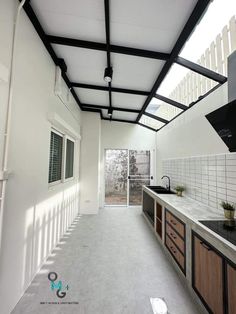 an empty kitchen with white walls and wood cabinets