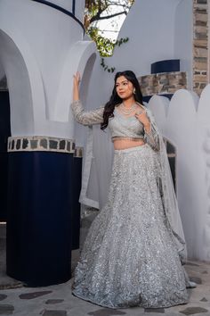 Item: Lehenga Set ( Lehenga Skirt, Blouse and Dupatta) Shine bright in our Silver Splendor Bridal Lehenga. Intricately crafted with exquisite detailing and craftsmanship, this breathtaking ensemble is sure to make you feel like royalty on your special day. Our team of artisans puts their heart and soul into every stitch, ensuring that each piece is a true work of art. With customization options available, you can personalize this lehenga to make it uniquely yours, ensuring you look and feel like Indian Wedding Lehengas, Wedding Lehengas, Special Occasion Gowns, Bridal Lehenga Collection, Skirt Blouse, Lehenga Skirt, Bridal Lehengas, Lehenga Collection, Saree Blouses