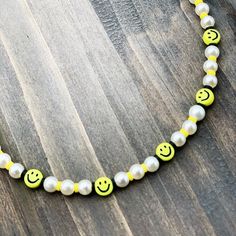 Smiley Face and Pearl necklace/ choker with multiple lengths available to chose from. Made with cute emoji beads, heishi beads and faux pearls. Fun, Trendy smiley face/ pearl necklace made with much appreciation from me to you. Happy days! Yellow Pearl Beaded Necklaces As Gift, Trendy Pearl Choker As Gift, Yellow Beaded Pearl Necklace Gift, Yellow Beaded Pearl Necklace As Gift, Trendy White Pearl Choker Necklace, Trendy Pearl Beaded Choker Necklace, Handmade Yellow Pearl Necklace For Gift, Trendy Adjustable Necklace With Pearl Charm, Trendy Beaded Choker With Pearl Chain