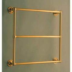 an old fashioned brass towel rack on the wall