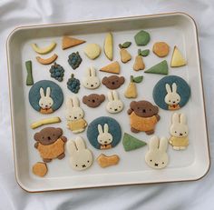 a white tray topped with different types of cookies