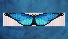 a blue butterfly is shown in the shape of a cross stitch pattern