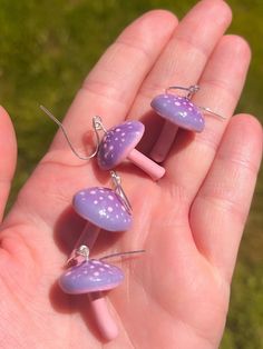 These purple and pink mushrooms are handmade from polymer clay and hand painted. Each mushroom is sculpted by hand individually, so some may vary slightly due to the nature of how they are made. However, they're all made with the same shape in mind!  Hardware is hypoallergenic for sensitive skin. Perfect for springtime and summer! 🌸 Whimsical Pink Polymer Clay Earrings, Cute Handmade Mushroom-shaped Earrings, Cute Handmade Mushroom Earrings, Handmade Cute Mushroom Earrings, Pink Mushroom Jewelry For Gifts, Mushroom Clay, Pink Mushrooms, Clay Mushroom, Pink Mushroom