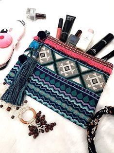 "Stay stylish and organized on the go with the Cotton Makeup Travel Bag with Tassels. This compact and chic bag is made from high-quality cotton and designed to keep your makeup essentials in order. With its spacious compartments and trendy tassel details, it perfectly combines functionality and fashion. Ideal for travel, this makeup bag offers ample space for your brushes, palettes, and skincare items. The durable cotton material ensures long-lasting use, while the secure zipper closure keeps e Multicolor Tassel Clutch For Everyday, Bohemian Pouch Cosmetic Bag For Travel, Bohemian Cosmetic Bag For Travel, Bohemian Cosmetic Pouch For Travel, Bohemian Rectangular Travel Cosmetic Bag, Makeup Travel Bag, Skincare Items, Makeup Travel, Chic Bags