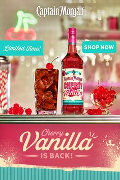 there is a bottle of cherry vanilla next to a glass with cherries on it