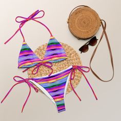 Stay comfortable and stylish all summer with this All-Over Print Recycled String Bikini set. It’s made from soft recycled polyester with double-layering and UPF 50+. Style the straps how you like, and get ready to swim! • Soft and stretchy material with UPF 50+ • Sizes up to 6XL • Bikini top comes with removable padding for comfort • Multiple ways to tie and style the bikini set • Color design options for swimwear lining Disclaimers: • Due to the 2-layered construction and internal stitching, a Summer Fitted String Swimwear, Fitted String Summer Swimwear, Fitted String Swimwear For Summer, Multicolor String Swimwear For Beach, Summer String Swimwear For Swimming, String Swimwear For Summer Swimming, Adjustable Multicolor Swimwear For Sunbathing, Summer String Swimwear For Sunbathing, Adjustable Multicolor Tie-side Swimwear Bottom