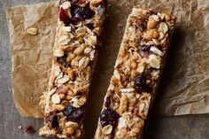 two granola bars sitting on top of brown paper