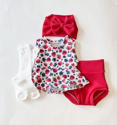 three pieces of clothing sitting on top of a white surface with red and blue flowers