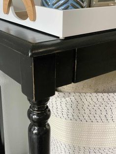 a close up of a black table with a white box on top