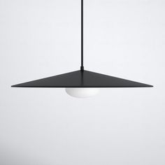 a black and white light hanging from a ceiling