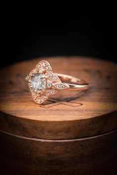 an engagement ring on top of a wooden box