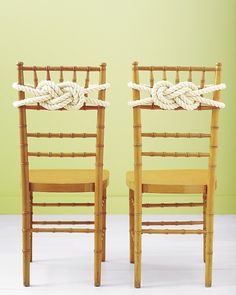 two wooden chairs with rope tied to them