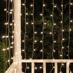 the lights are strung up on the porch railing to create a beautiful backdrop for this outdoor space