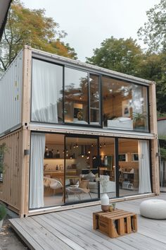 a house made out of shipping containers with sliding glass doors on the front and side