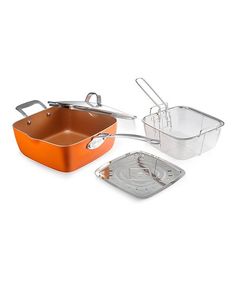 an orange casserole with two pans and one strainer on the side