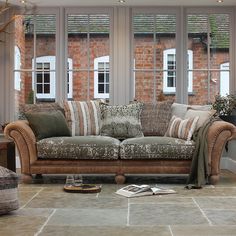 a living room filled with furniture and windows