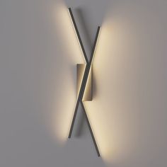 two lights that are next to each other on a wall with the same light in front of them