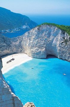 an aerial view of the blue water and cliffs