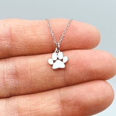 This precious tiny paw print charm necklace comes in sterling silver and gold, with a delicate adjustable link chain. It makes a perfect gift for you and your dog- or cat-loving friends and family. Material: * Sterling Silver * Gold Plated Sterling Silver Size: * Pendant: 3/8" wide (9mm) * Adjustable 16"-18" chain length Silver Paw Print Round Pendant Necklace, Paw Print Pendant Necklace Gift, Paw Print Pendant Necklace For Gifts, Pendant Necklace With Paw Print For Gift, Paw Print Pendant Necklace For Gift, Silver Necklace With Paw Print For Gift, Sterling Silver Paw Print Necklace As Gift, Sterling Silver Paw Print Necklace For Gift, Sterling Silver Paw Print Necklace