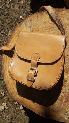 Small Beige Leather Bag, crafted from 100% leather, boasts a light brown color and simple form. 100% Leather Compact Size Unlined Natural Interior: Interior 1 large compartment, unlined, natural raw leather interior. Dimensions Height: 6 1/2" / 17 cm Width: 6 1/2" / 17 cm Depth: 2" / 4,5 cm Strap: adjustable, max 110 cm / 43" Condition The bag is in nice vintage condition with one mentionable flaw: pictured on the last photo - there is a white color flaw at the beginning of the strap. Classic Brown Pouch Saddle Bag, Classic Brown Saddle Bag Pouch, Classic Saddle Bag With Leather Strap For Daily Use, Classic Beige Satchel As Gift, Classic Brown Shoulder Bag With Leather Strap, Brown Vegetable-tanned Saddle Shoulder Bag, Classic Brown Saddle Bag Gift, Brown Vegetable-tanned Saddle Bag For Everyday Use, Brown Leather Saddle Bag With Vegetable-tanned Details