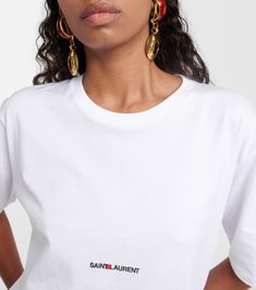 Logo cotton T-shirt in white - Saint Laurent | Mytheresa Classic Tops With Embroidered Logo For Summer, Classic Summer Tops With Embroidered Logo, Classic Tops With Logo Print For Workwear, White Crew Neck T-shirt For Workwear, Cotton Workwear Tops With Logo Print, Classic Graphic Print Workwear Top, Classic Graphic Print Top For Work, Classic Graphic Print Top For Workwear, Style Definition